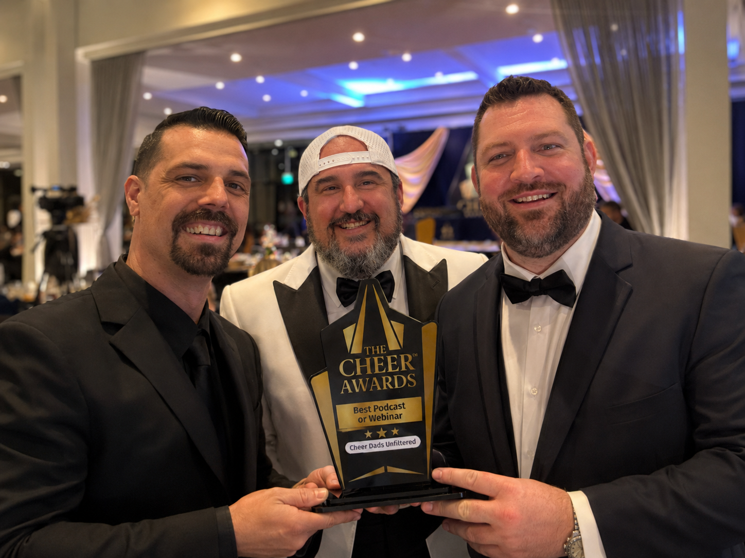 Tom, Geoff, and David of Cheer Dads Unfiltered holding the 2026 Cheer Award trophy for Best Podcast or Webinar